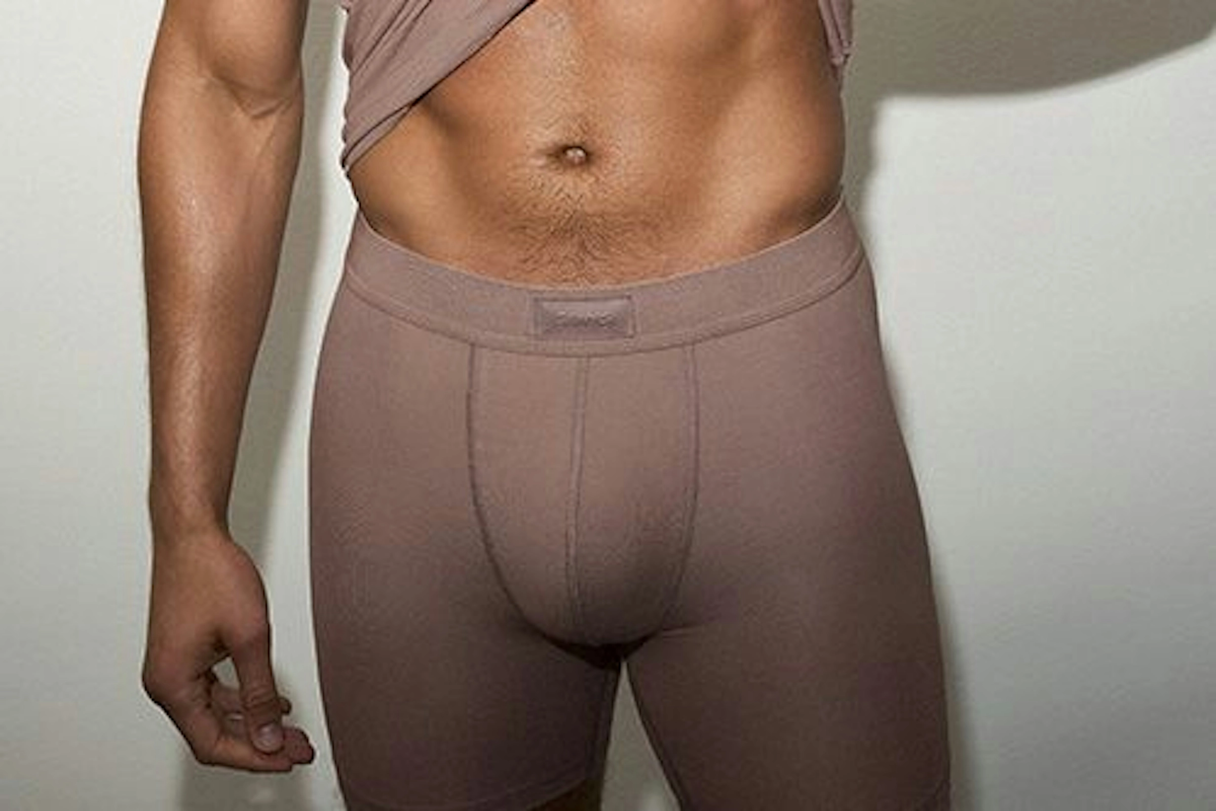 A close crop of a man in mocha boxer briefs