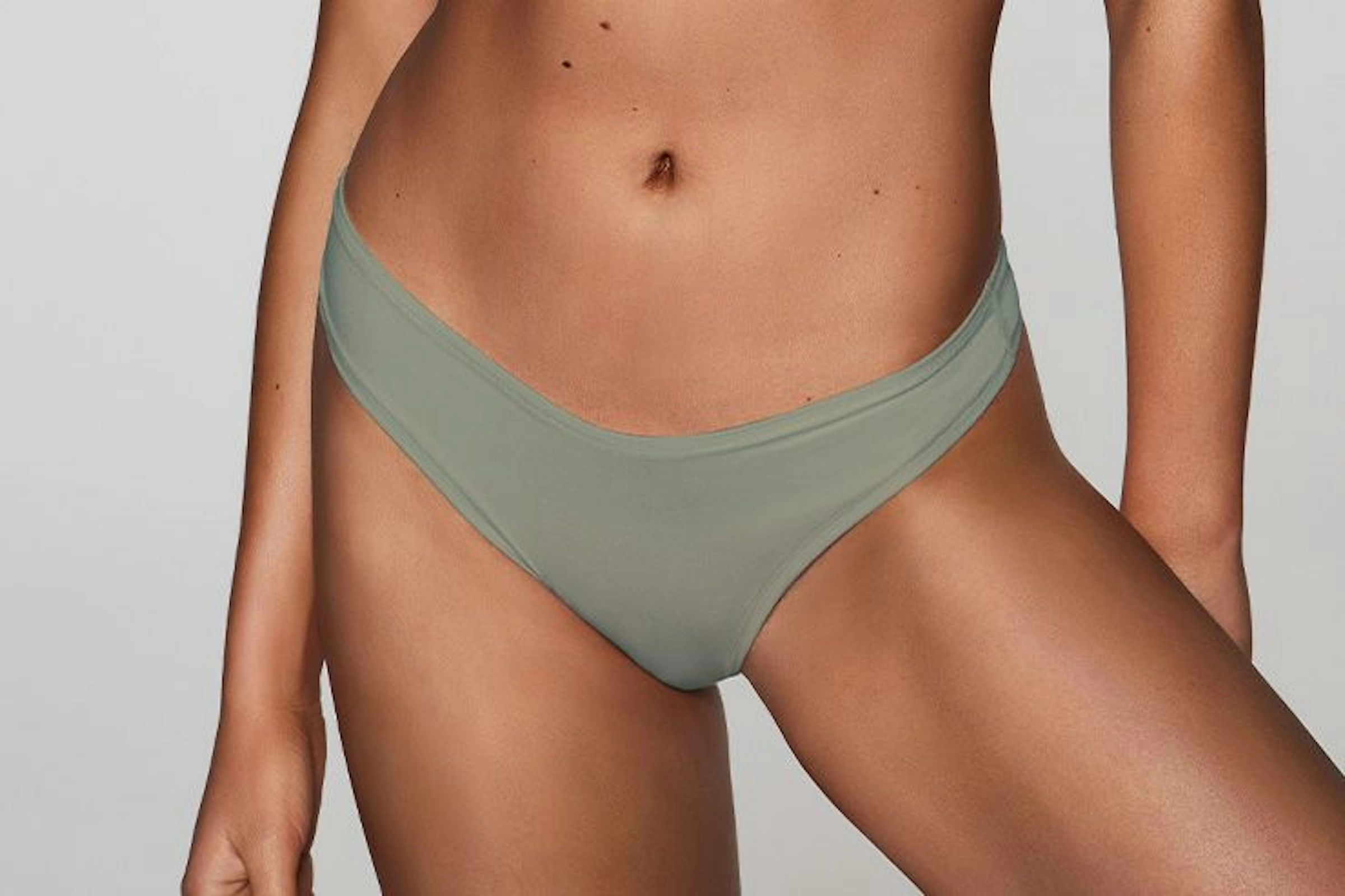 A sage green thong on a model