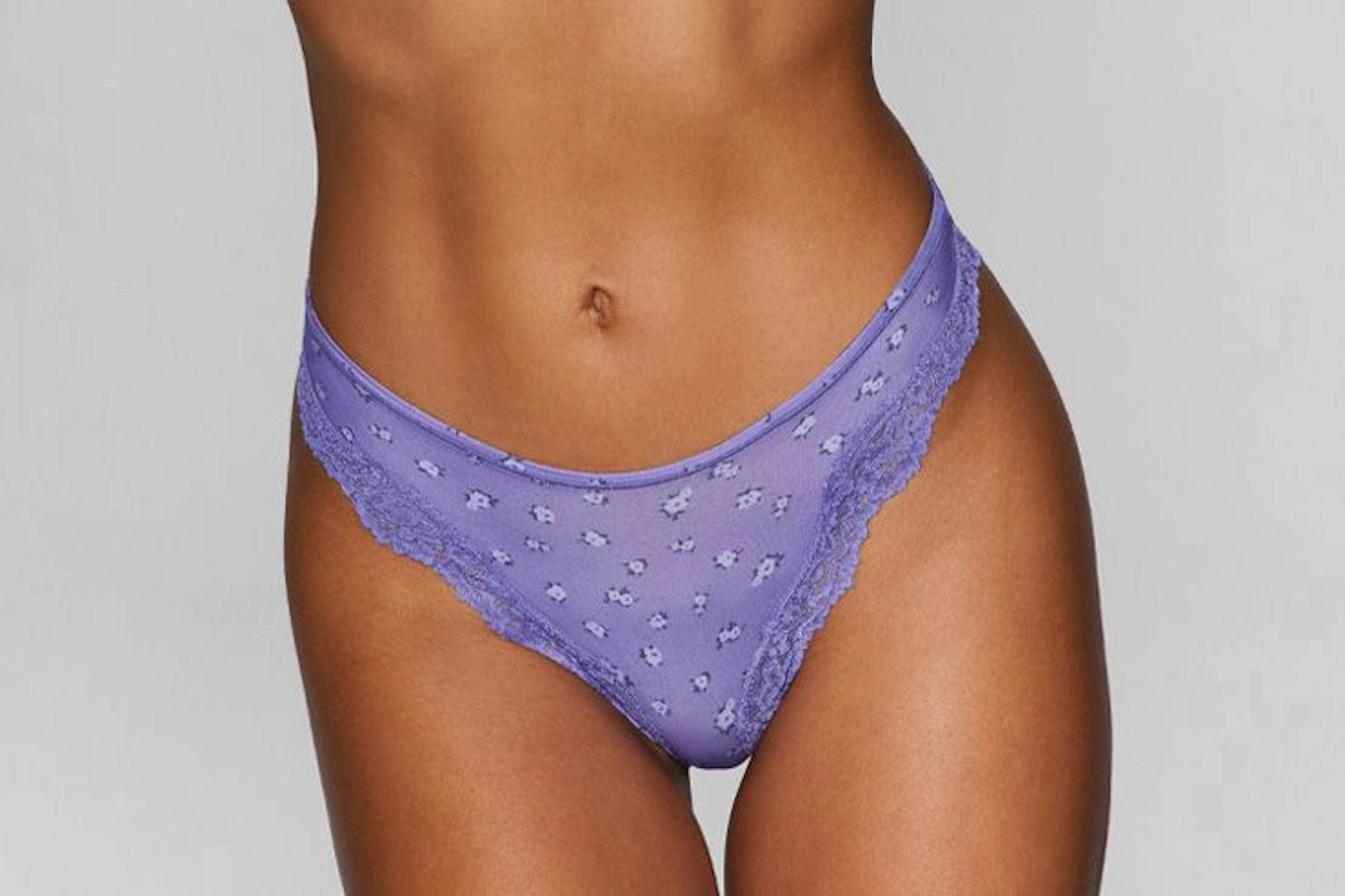 A purple lace thong on a model
